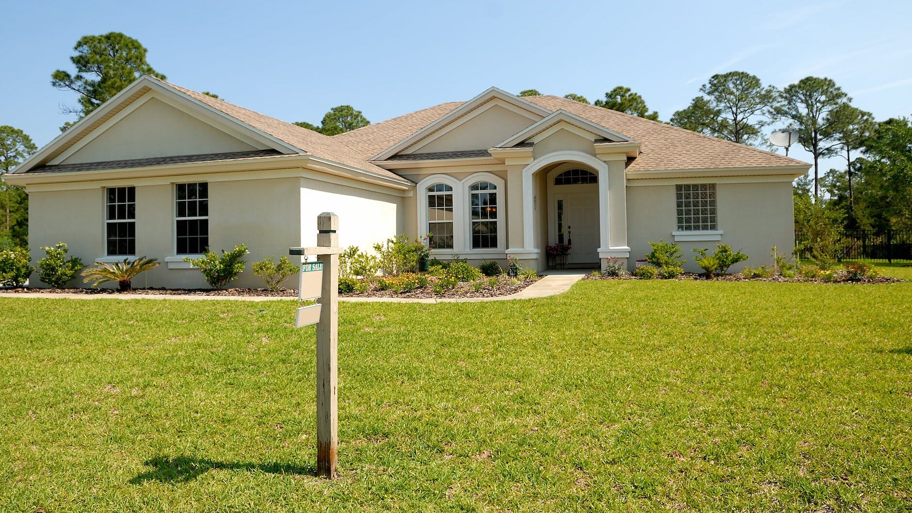 white and brown concrete bungalow under clear blue sky