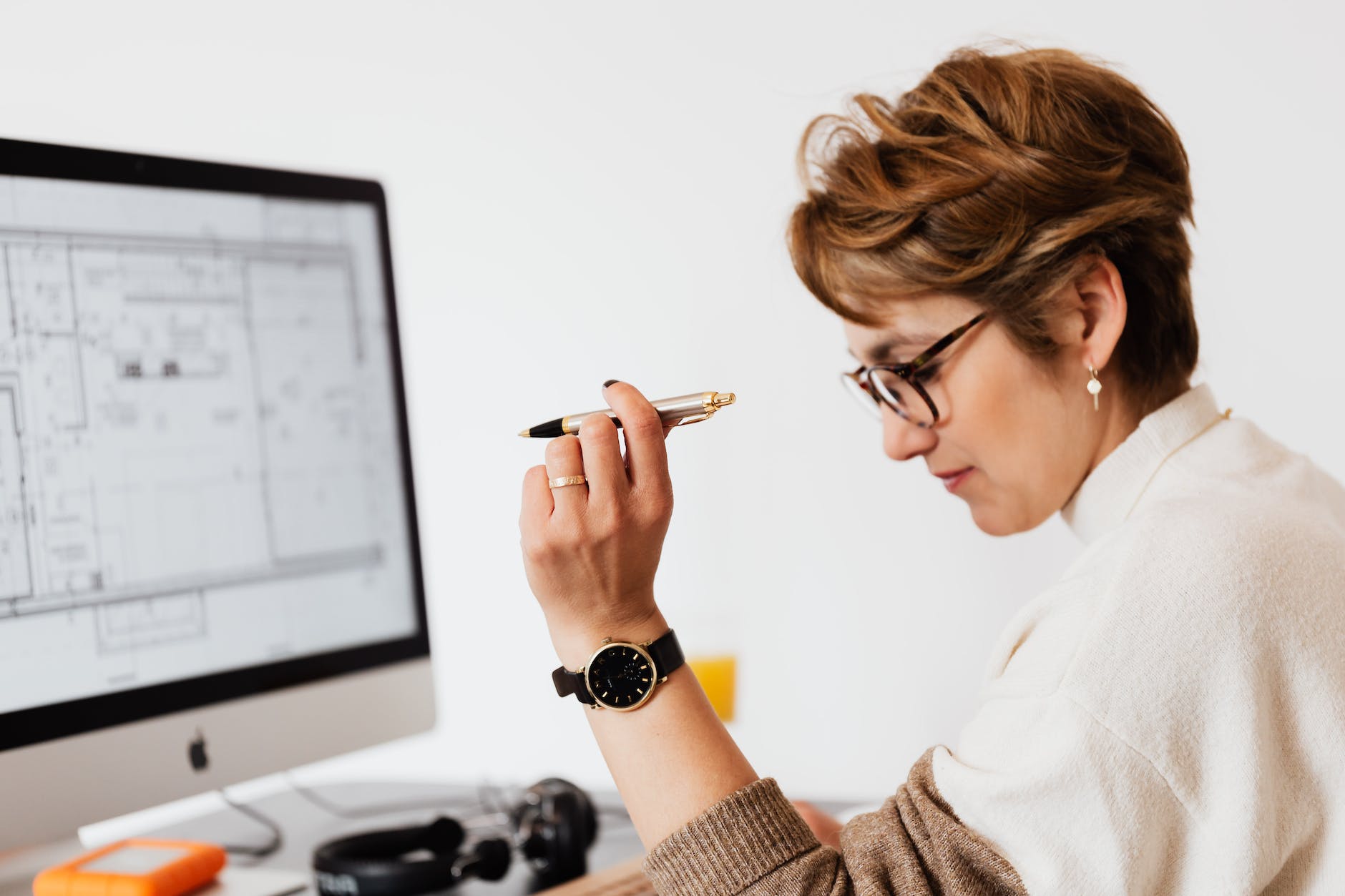 concentrated adult female thinking about business project in office