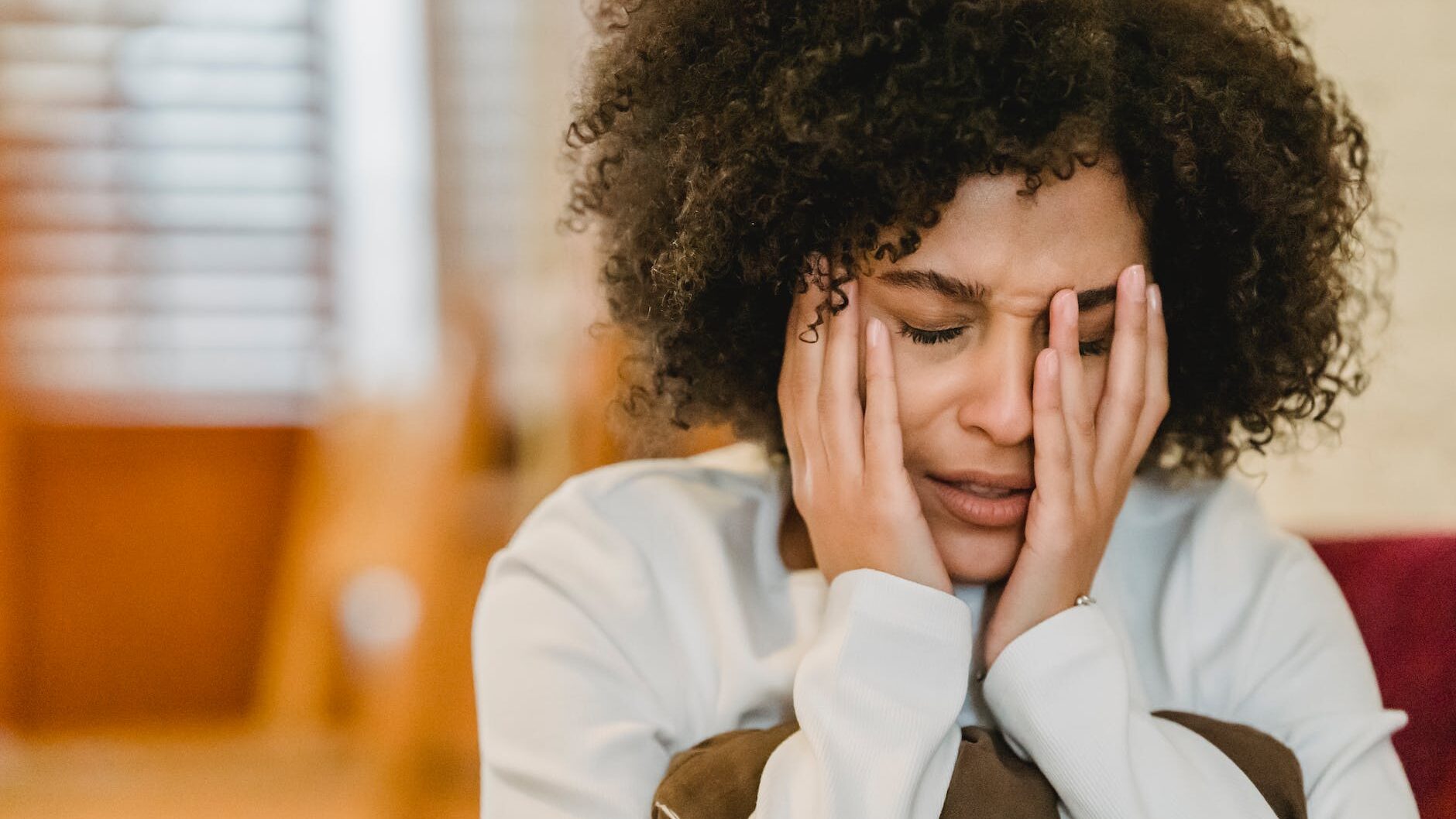 frustrated black woman sitting in room