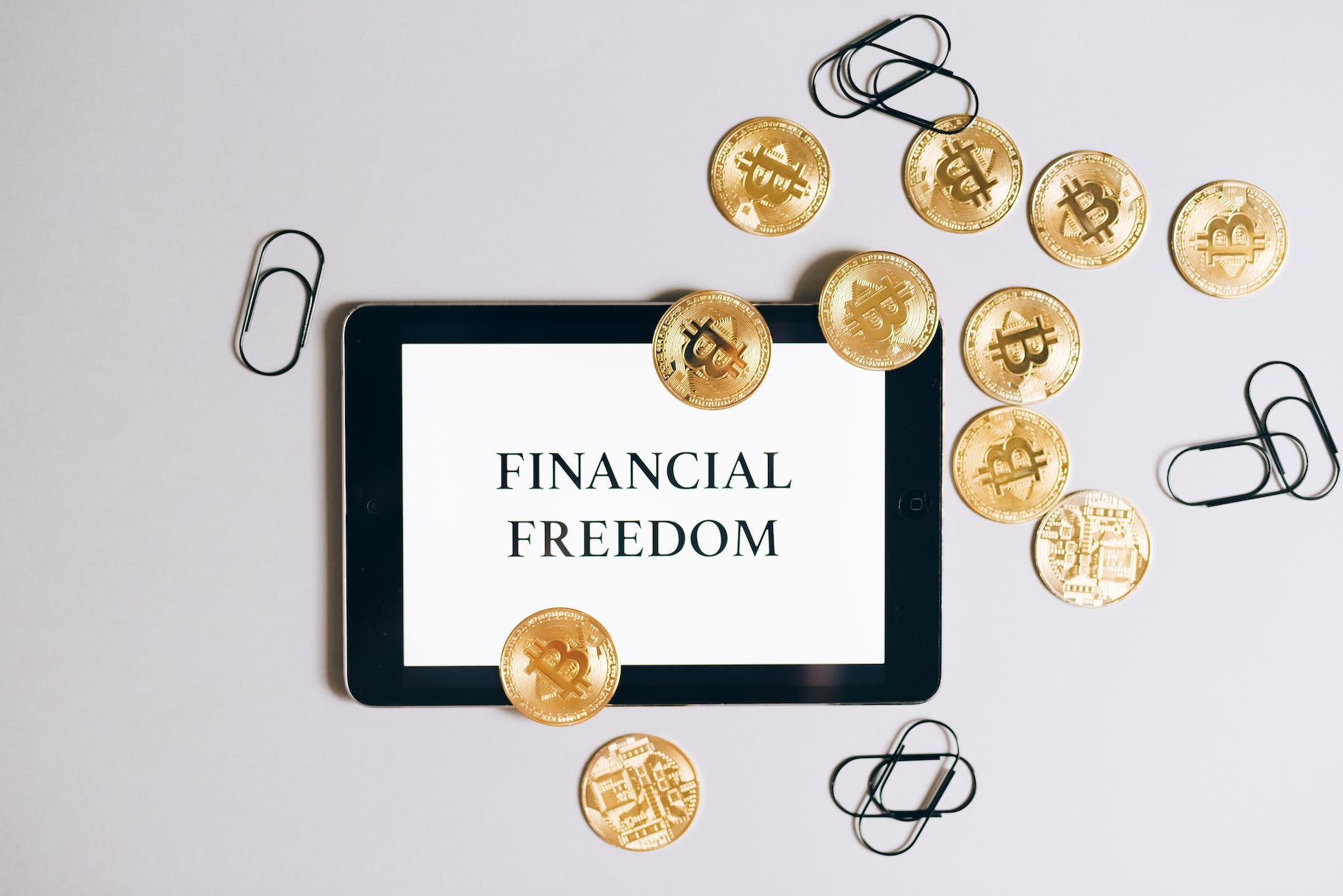 overhead shot of a tablet and bitcoins