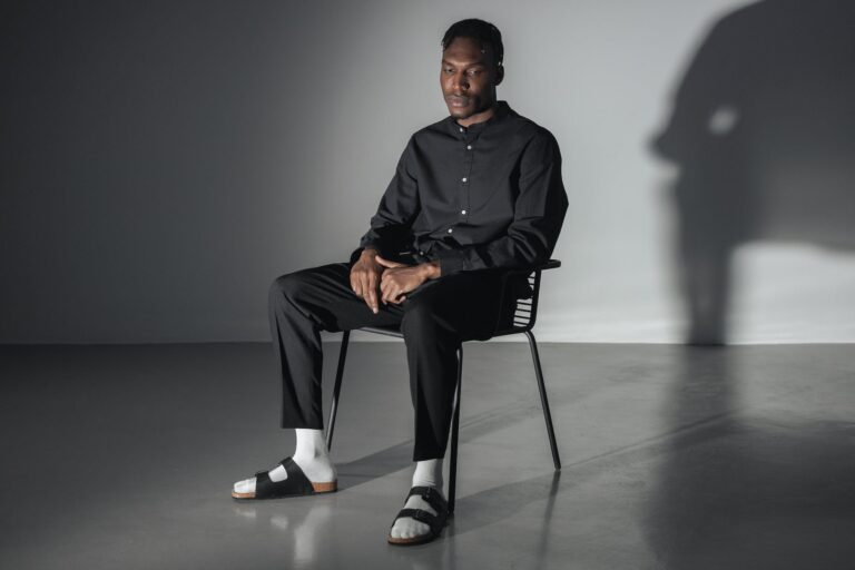 man in black button up shirt sitting on black chair