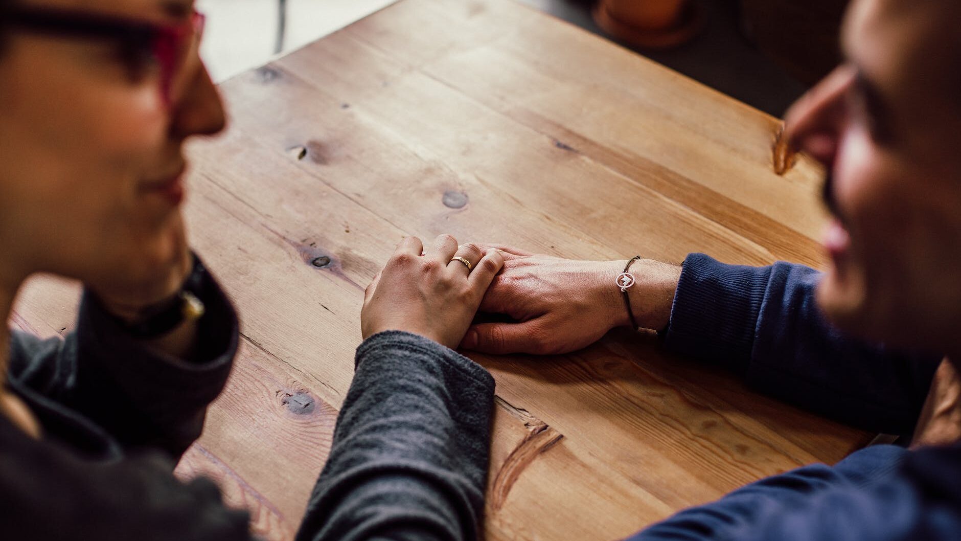 man and woman sitting together in front of table