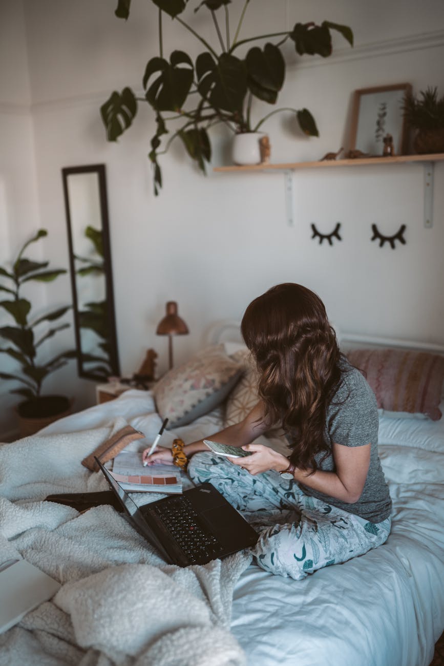 photo of woman sitting on bed